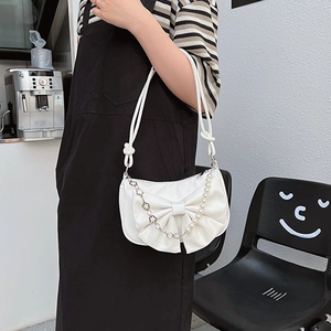 White PU leather bow shoulder bag with pearl chain and floral metal strap accents