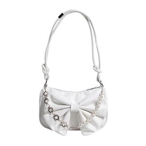 White leather shoulder bag with large bow and decorative pearl chain on white background