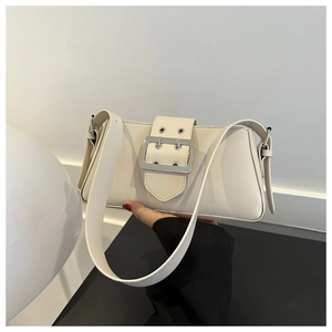 Detail of a minimalist off-white underarm bag with a large silver buckle and wide strap