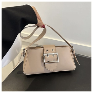Detail of minimalist beige baguette bag with smooth leather finish and silver buckle