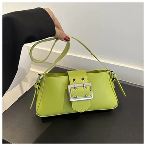 Detailed view of the neon green underarm bag with a large silver metal buckle and PU leather