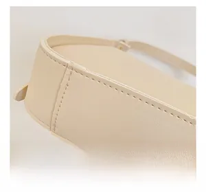 Dettaglio delle cuciture precise sul fondo e sui lati della borsa a tracolla in pelle beige