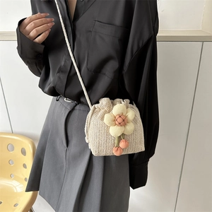 Mini straw woven bucket bag with floral accent and cotton rope strap for women