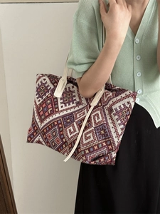 Ethnic geometric canvas tote bag with colorful woven patterns and faux leather straps