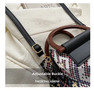 Detail of adjustable strap buckle on ethnic style handbag with jacquard fabric