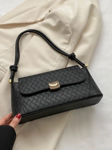 Fashionable black quilted leather underarm bag with gold metal buckle and knot strap detail