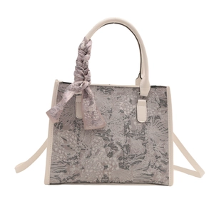 Women's large canvas tote bag with artistic pattern and decorative scarf handle detail