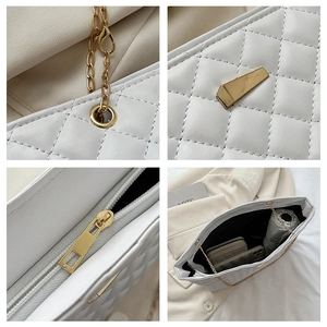 Close-up of white quilted chain bag showing stitching, gold hardware and spacious interior