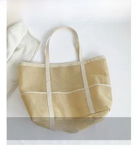 Close-up of beige mesh tote bag showing breathable texture and durable canvas straps