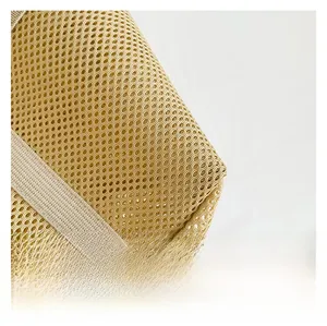 Detail of breathable honeycomb mesh fabric and reinforced webbing on khaki shoulder bag
