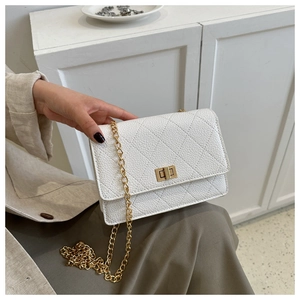 Detail of white quilted crossbody bag with golden chain strap and metallic twist lock