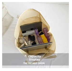 Spacious interior of beige mesh beach tote bag showing laptop and accessories