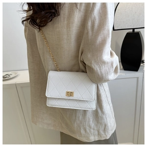 Detailed view of white quilted crossbody bag with gold chain and lychee leather texture