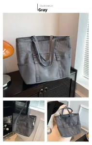 Macro view of grey mesh beach bag showing storage pockets and durable fabric handles