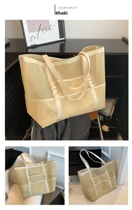 Detail view of khaki mesh tote bag showing breathable woven fabric and reinforced handles
