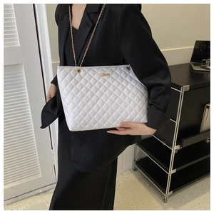 Detailed view of white quilted PU leather shoulder bag with gold chain and metal hardware