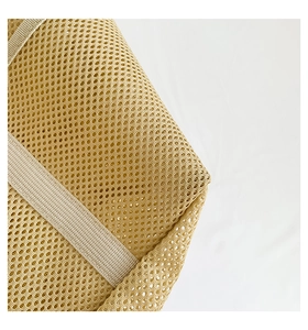 Close-up of yellow mesh beach bag material showing breathable honeycomb knit fabric