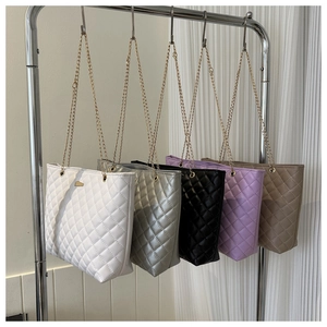Detailed row of quilted tote bags in five colors with golden chain straps and PU leather finish