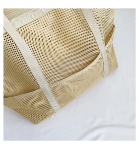 Detail of beige mesh beach tote showing durable grid texture and side pocket construction