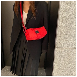 Detailed shot of a red waterproof sports bag with durable plastic buckle and strap