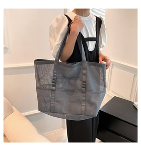 Detail view of the gray mesh tote bag with functional multi-pockets and shoulder straps