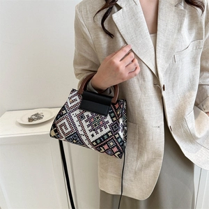 Ethnic style woven handbag with wooden ring handle and colorful geometric patterns