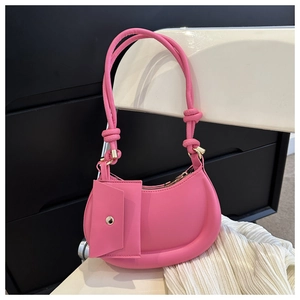 Detail of hot pink hobo bag with knotted dual straps and detachable coin purse accessory