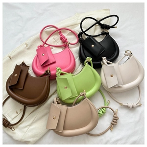 Top view of colorful half-moon crossbody bags set in matte leather with knotted straps