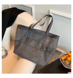 Detail of grey mesh tote bag showing large main compartment and front dual outer pockets