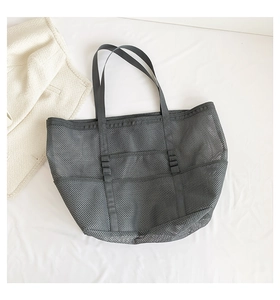 Detailed top view of grey mesh beach bag showing breathable texture and front pockets