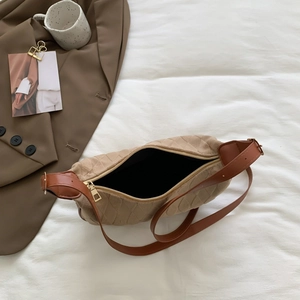 Contrast color diamond quilted hobo bag with adjustable strap on white aesthetic backdrop