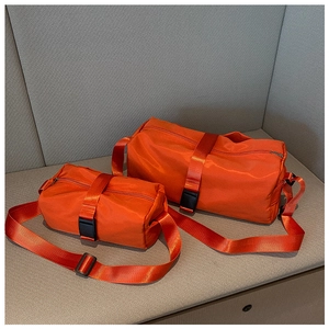 Detail of waterproof orange nylon fitness bags in two sizes with buckle straps