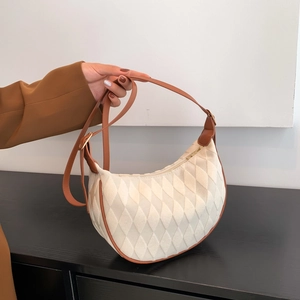 Minimalist beige quilted hobo bag with brown leather trim and golden metal hardware
