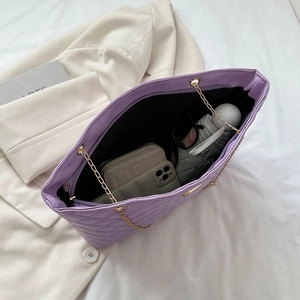 Purple quilted chain tote bag showing large capacity for essentials on white background