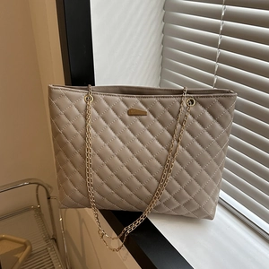 Quilted beige shoulder bag with gold chain strap and spacious interior tote design