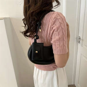 Minimalist black half-moon underarm bag with knot strap and small card pouch detail