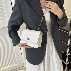 Elegant white quilted crossbody bag with gold chain strap and turn-lock closure