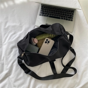 Large black waterproof fitness bag with spacious interior for travel essentials and gadgets