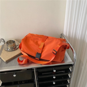 Large orange waterproof sports gym bag with adjustable shoulder strap for travel