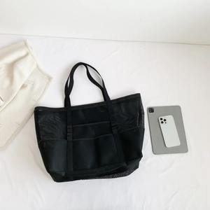 Large black mesh beach tote bag with multiple pockets and durable shoulder straps
