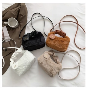 Flat lay of soft plush handbags in four colors with ruffled handles and crossbody straps
