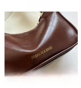 Detailed macro view of dark brown leather texture with golden Fashion and Bags lettering