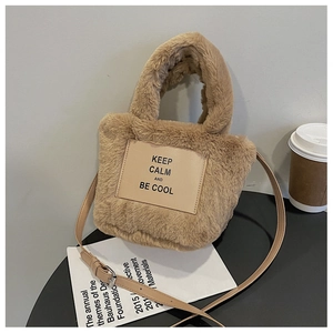 Detail of khaki plush bucket bag showing faux fur texture and keep calm leather patch