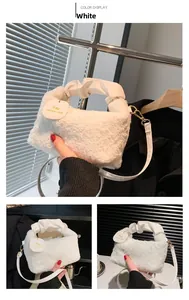 Detail of white faux fur handbag with ruched leather handle and golden metal hardware