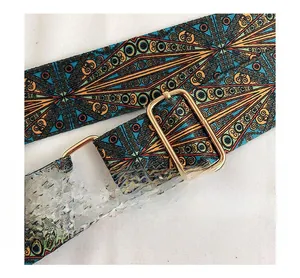 Detail of adjustable bohemian wide strap with geometric embroidery and gold hardware