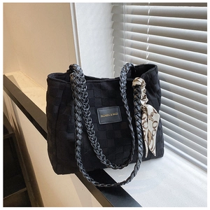 Detail of black woven tote bag with silk scarf and Fashion & Bags leather logo