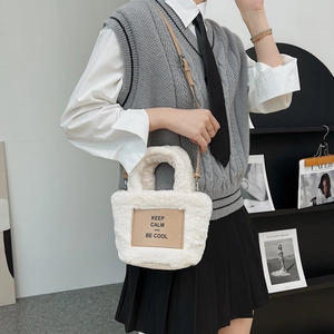 Chic cream faux fur bucket bag with leather strap and Keep Calm patch for women