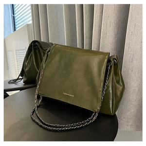 Detail of olive green PU leather tote bag with FASHION BAGS text and chain strap