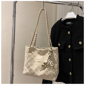 Detail of off-white woven tote bag with silk scarf and FASHION & BAGS leather label