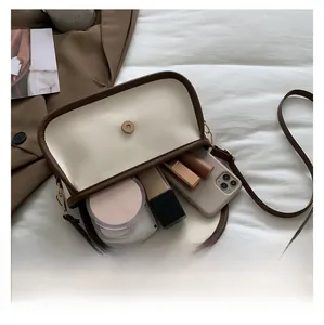 Detail view of the spacious inner compartment of the bicolor vintage crossbody bag